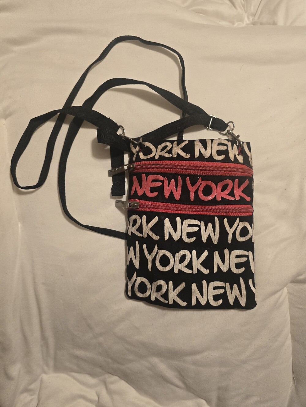 Robin Ruth Black Crossbody Bag with Red Zippers and White Script